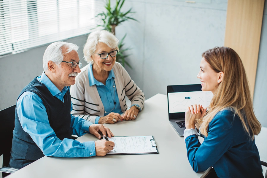 Elderly couple meeting with financial advisor.