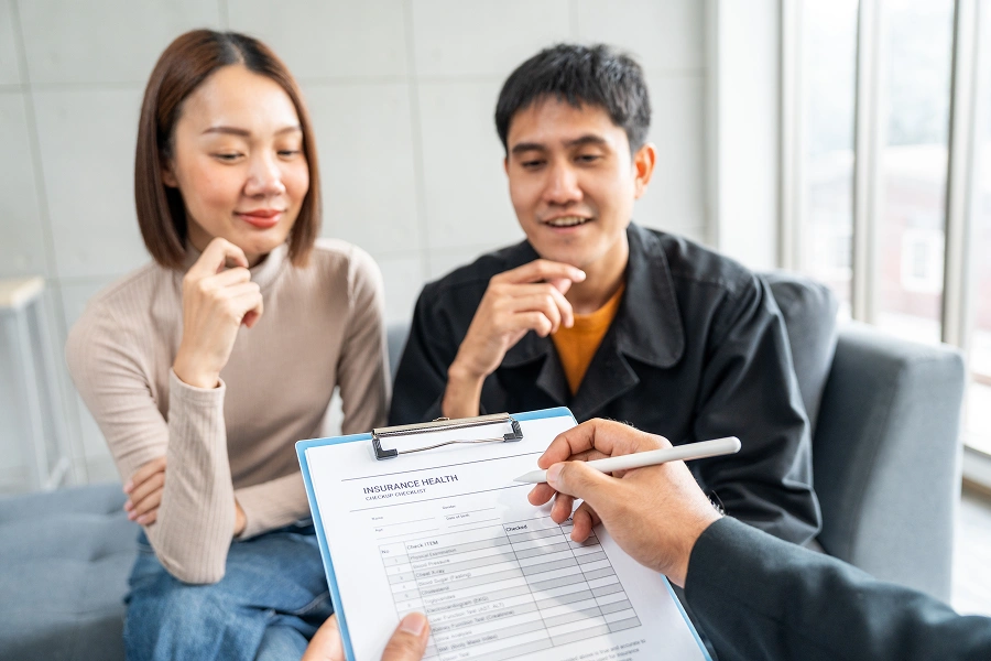 Couple reviewing a document with advisor.