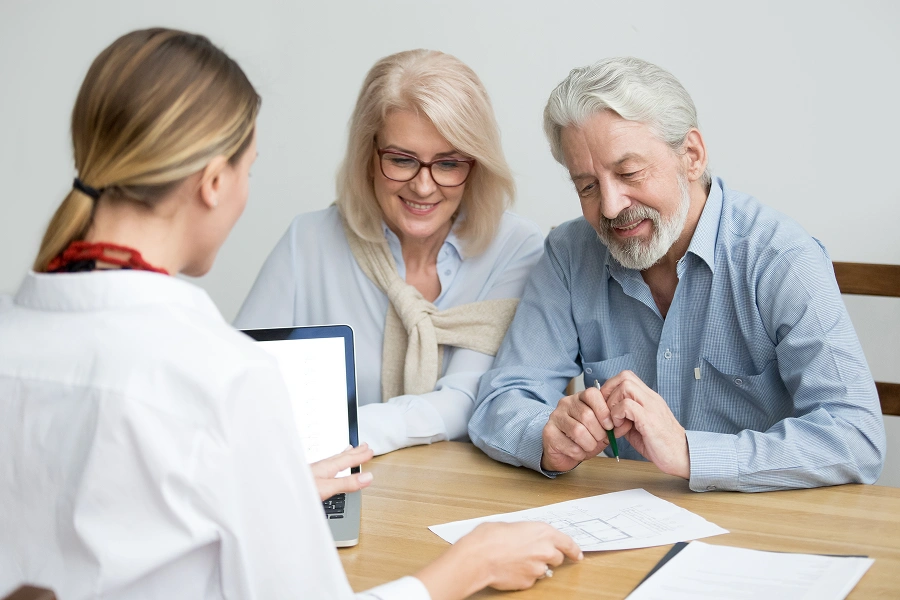 Couple consulting with a professional at desk.