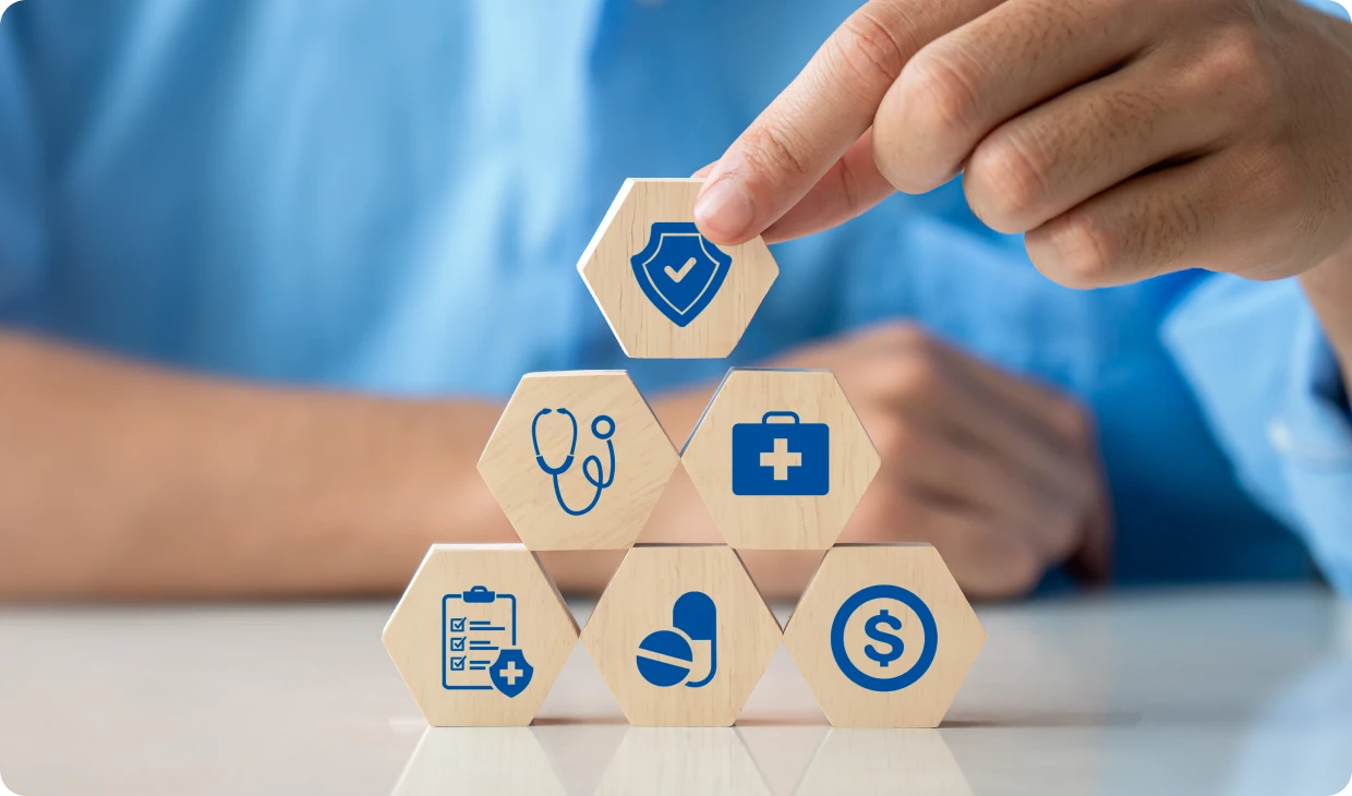 Healthcare icons on wooden hexagonal blocks.