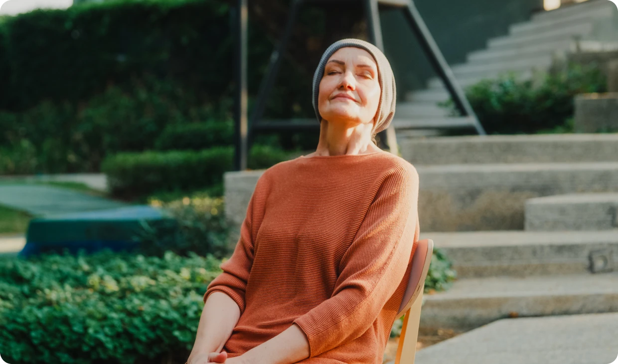 Elderly woman relaxing outside on a chair.